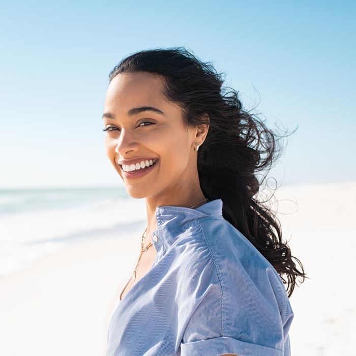smiling young woman on beach