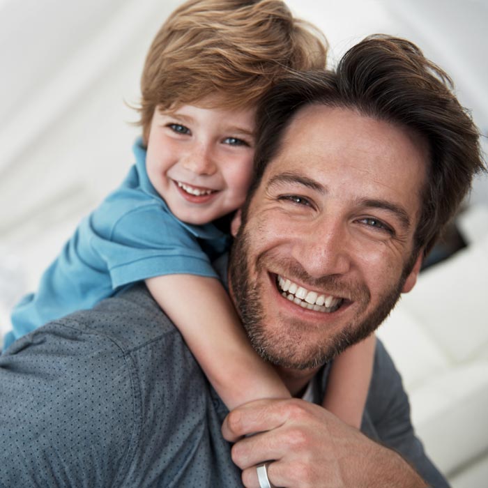 smiling father and young son